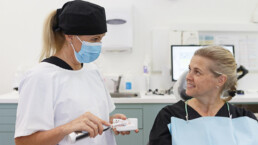 Dental hygienist talking with patient at Cleeland Dental